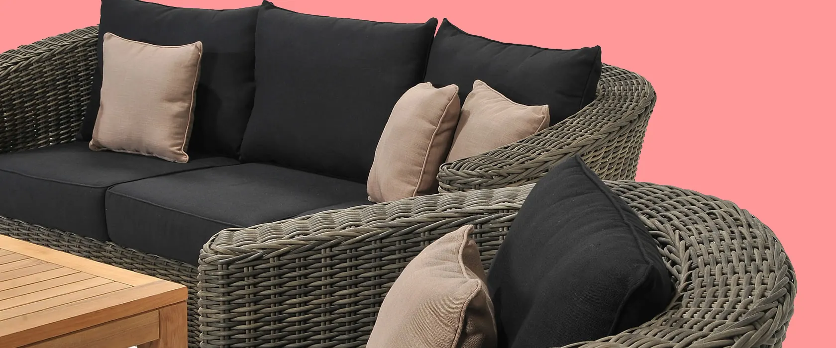 Dark rattan sectional sofa with plush cushions